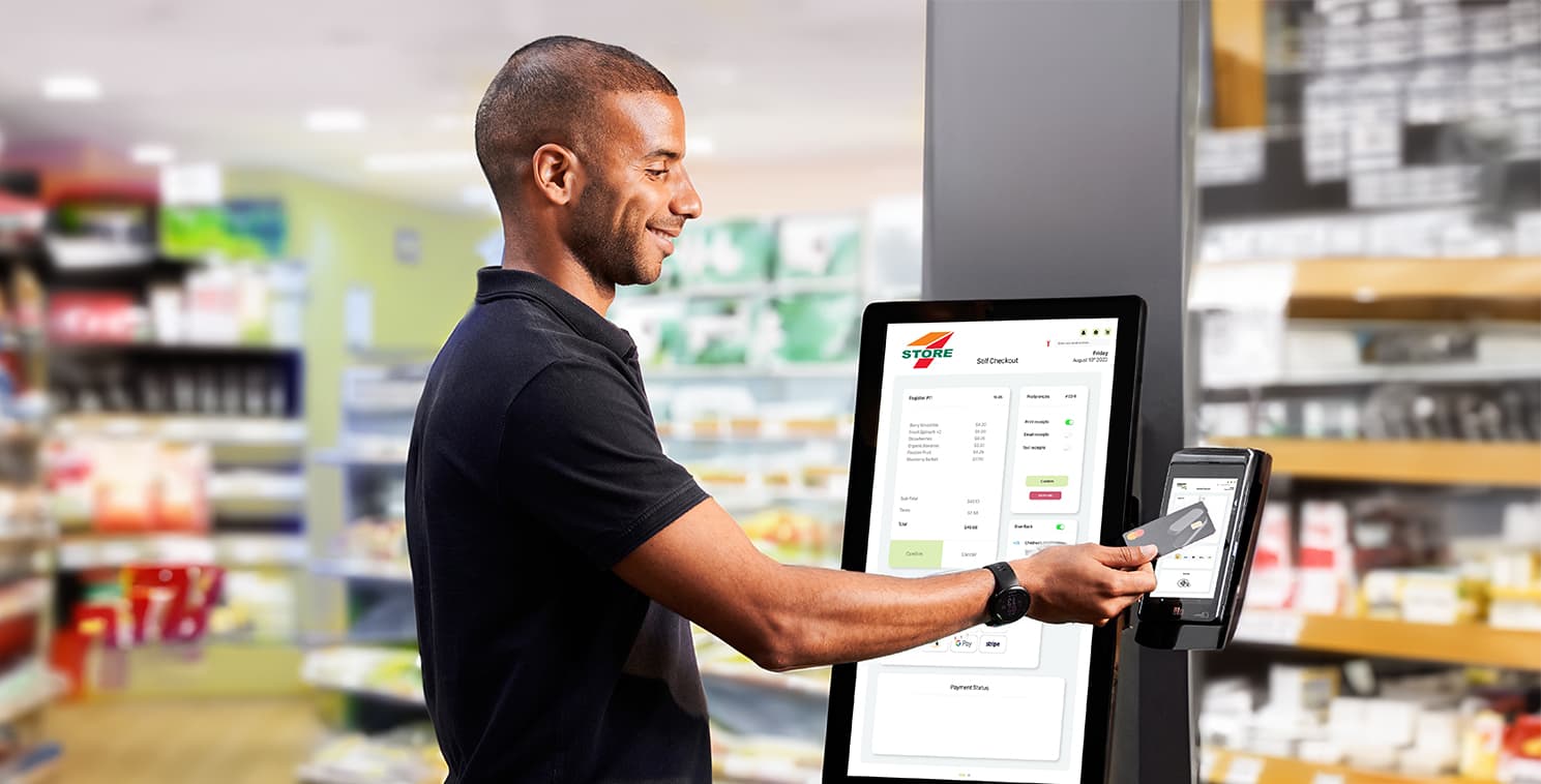 Customer using a mobile POS touchscreen to complete a transaction in a convenience store, illustrating modern point-of-sale technology beyond the checkout counter.